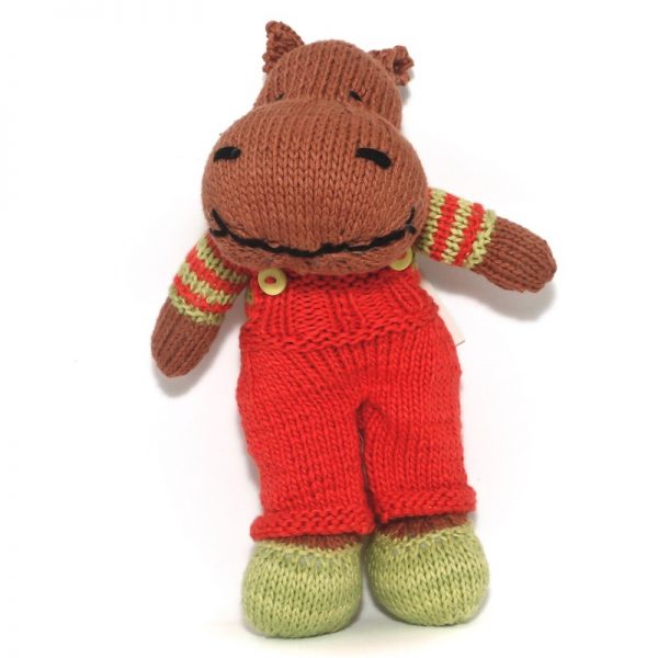Image of hand knitted hippo Fred with green shoes and red dungerees, green and red striped jersey